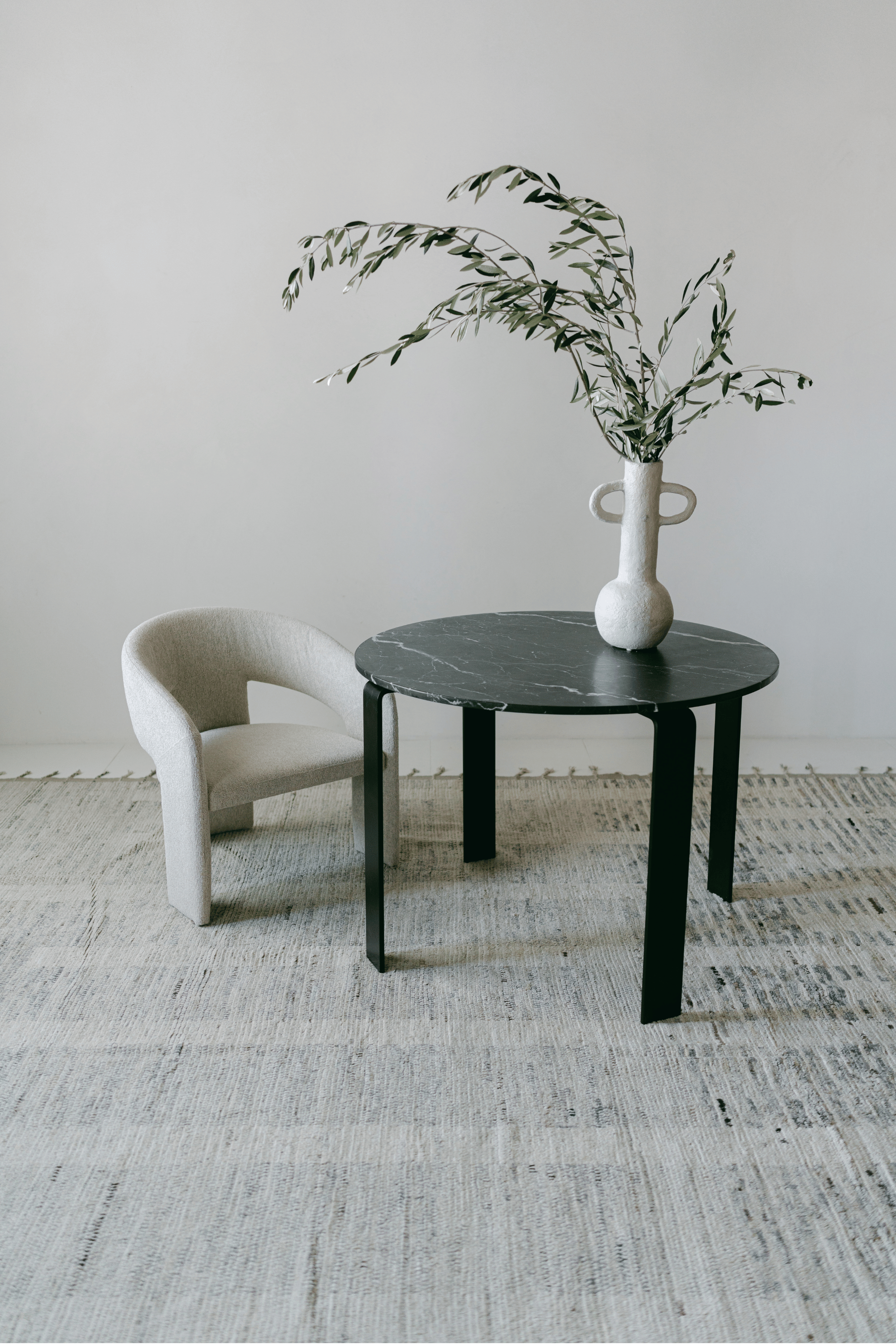 District Loom Furniture Nero Marquina Marble round table honed finish locally sourced from natural marble stone remnant and handcrafted to serve as a sustainable sculptural element in your home