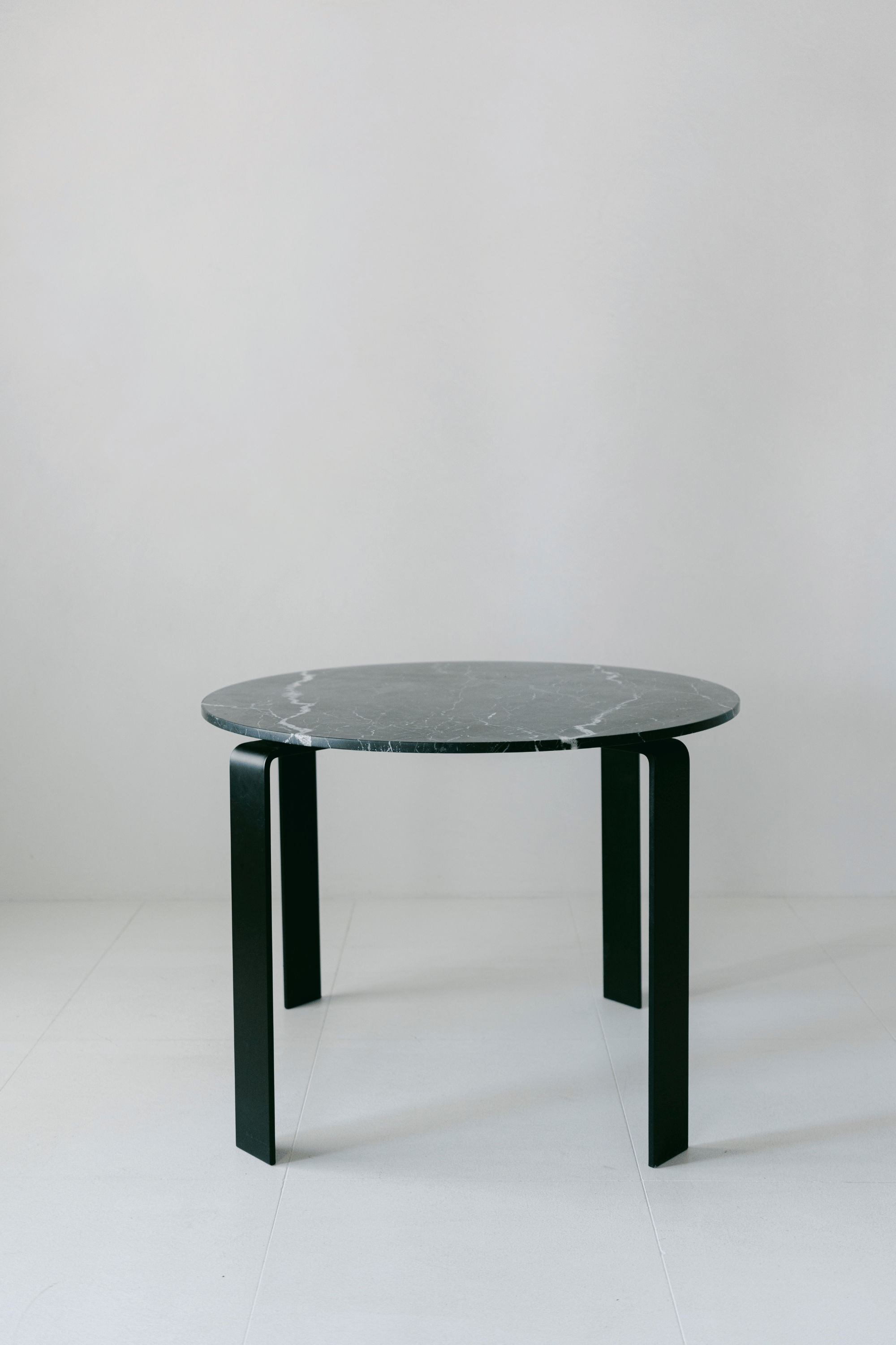 District Loom Furniture Nero Marquina Marble round table honed finish locally sourced from natural marble stone remnant and handcrafted to serve as a sustainable sculptural element in your home